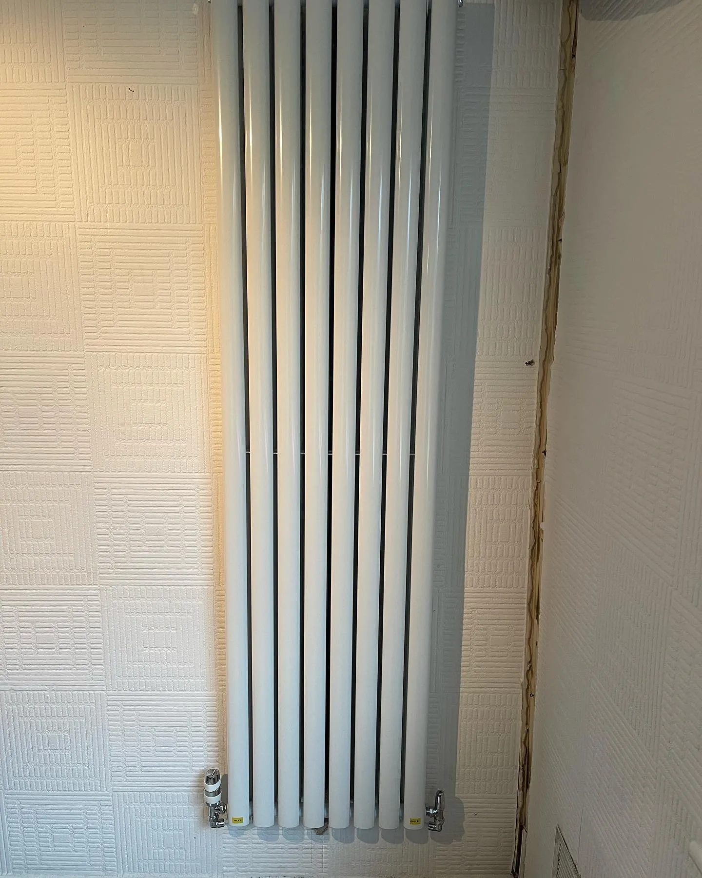A bathroom with a toilet and a radiator.